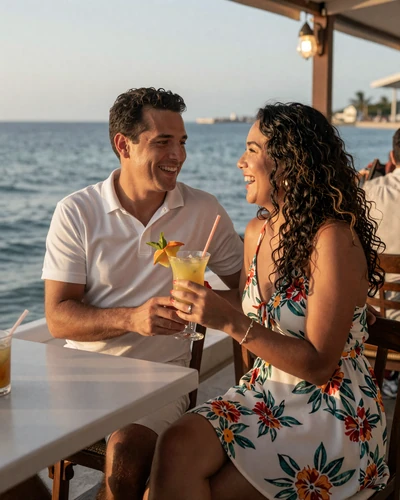 Happy American man and Dominican woman laughing together at a Santo Domingo waterfront restaurant