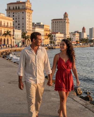 American man and Cuban woman walking hand in hand along the Havana Malecón at sunset