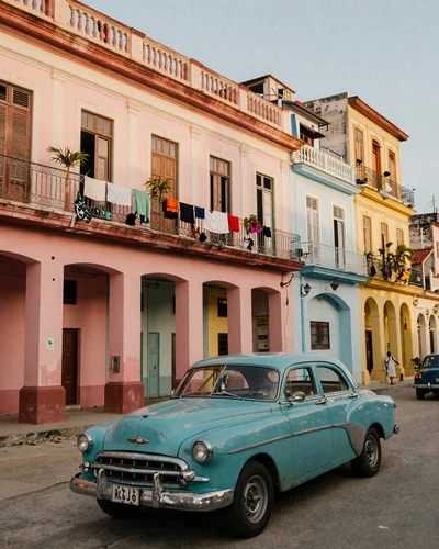 Colorful Old Havana street with pastel colonial buildings and a classic vintage American car
