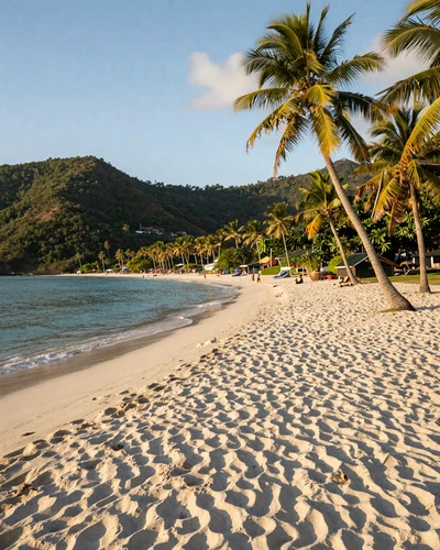 Grand Anse Beach in Grenada with white sand, turquoise Caribbean water, and lush green hills in the background